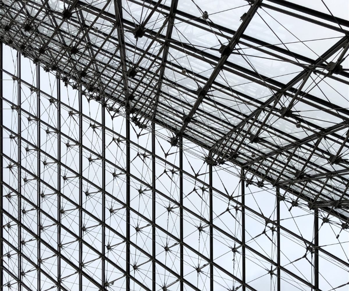Steel space frame supporting a glazed roof, seen from below