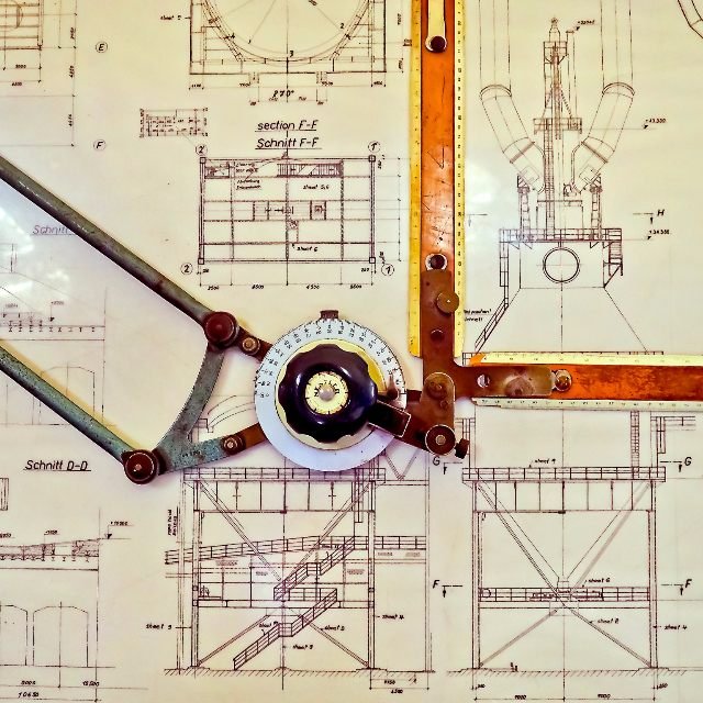 Detailed engineering drawing with a drafting instrument